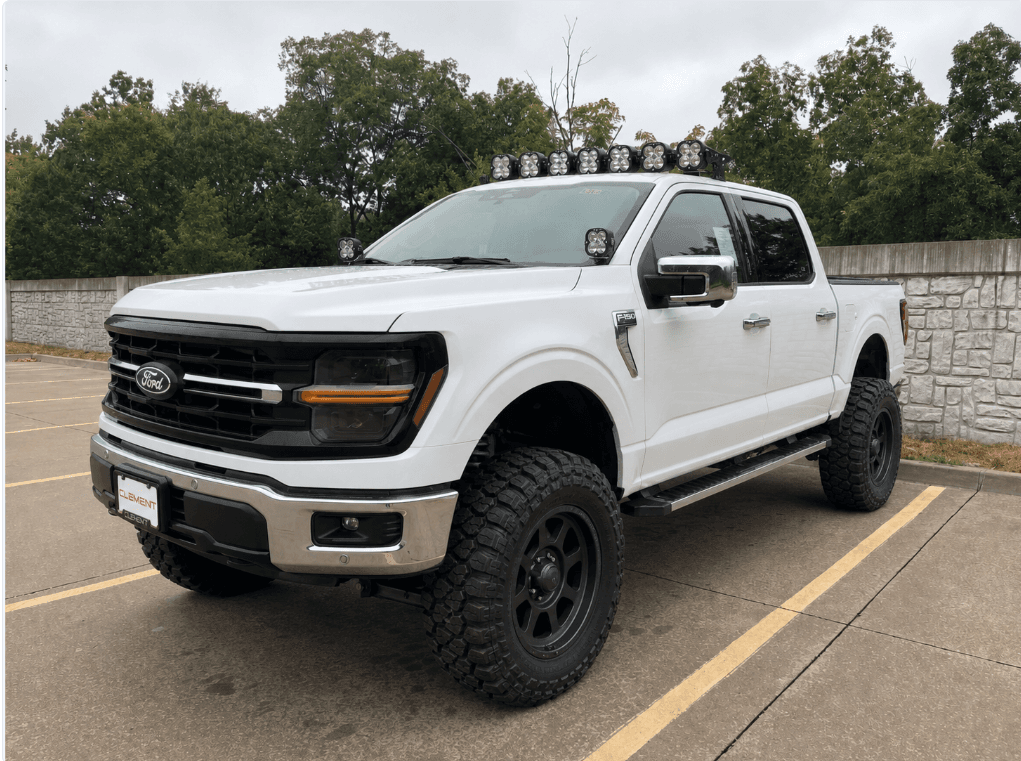 BiltRides concept showing a white F-150 with dark wheels, off-road tires, a lift and lights